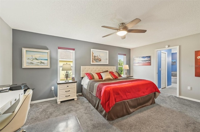 carpeted bedroom featuring ceiling fan, ensuite bath, and a textured ceiling