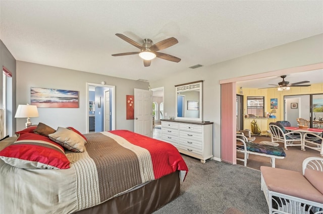 bedroom with ceiling fan, carpet floors, and a textured ceiling