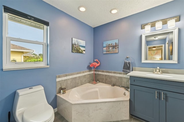 bathroom featuring a bathing tub, tile patterned flooring, vanity, toilet, and a textured ceiling