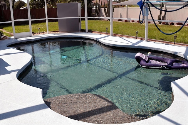 view of pool featuring a yard