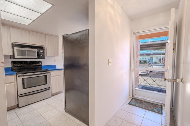 kitchen with black appliances and light tile patterned floors