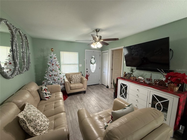 living room featuring ceiling fan and light hardwood / wood-style flooring