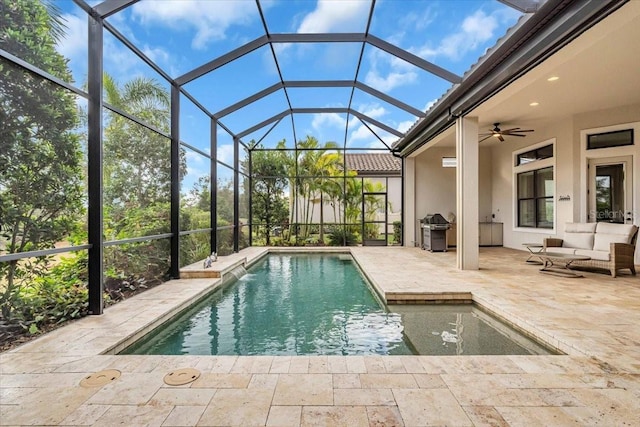 view of swimming pool with ceiling fan, a grill, a patio, and glass enclosure