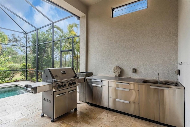 view of patio / terrace with area for grilling, sink, glass enclosure, and grilling area