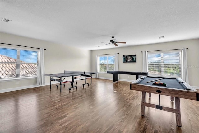 recreation room with a textured ceiling, ceiling fan, dark wood-type flooring, and billiards