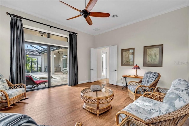 living room with ceiling fan, light hardwood / wood-style flooring, and ornamental molding