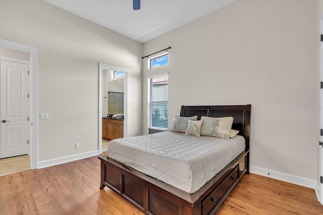 bedroom featuring ensuite bath, ceiling fan, and light hardwood / wood-style flooring