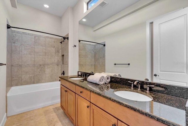 bathroom featuring tile patterned floors, vanity, and tiled shower / bath combo