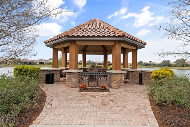 view of patio / terrace featuring a gazebo and a water view