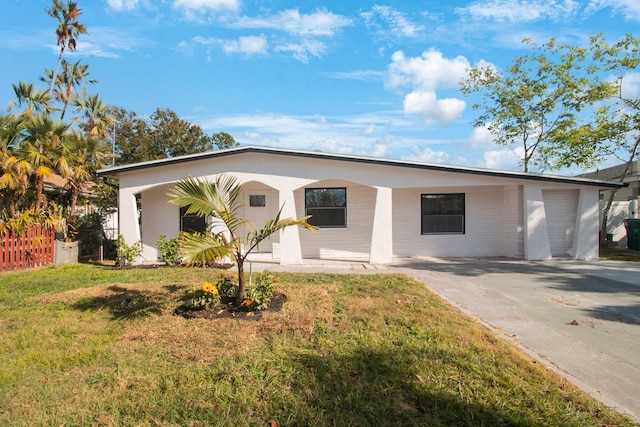 single story home with a garage, a front lawn, and a carport