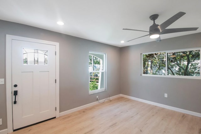 foyer entrance featuring ceiling fan and light wood-type flooring