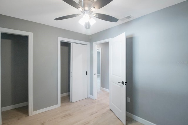 unfurnished bedroom featuring a closet, ceiling fan, and light wood-type flooring