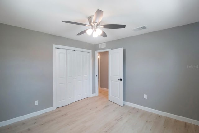 unfurnished bedroom with ceiling fan, a closet, and light hardwood / wood-style flooring