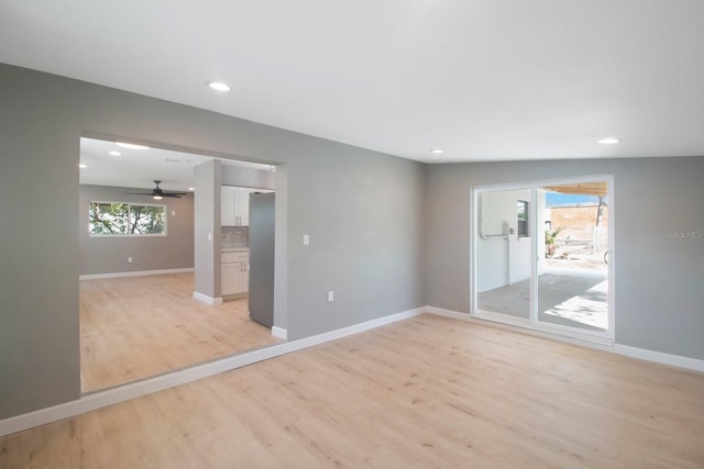 empty room featuring ceiling fan and light hardwood / wood-style flooring