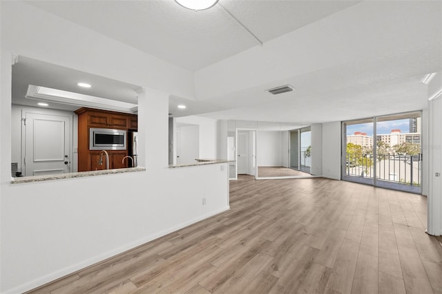 unfurnished living room featuring light hardwood / wood-style floors