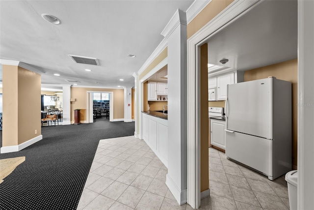 interior space with light tile patterned flooring and ornamental molding