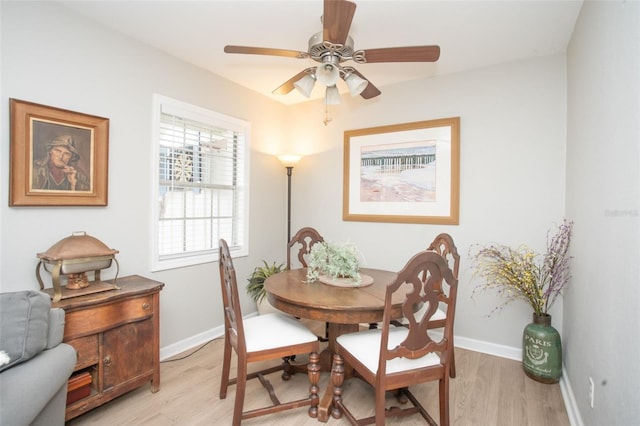 dining space with light wood-type flooring and ceiling fan