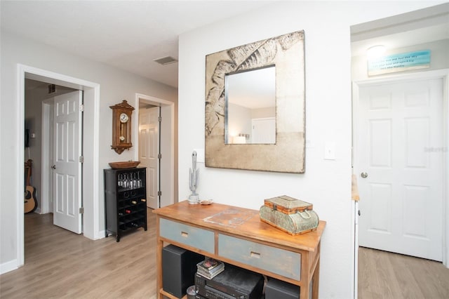 hallway with light hardwood / wood-style flooring