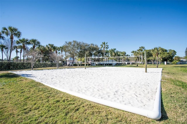 surrounding community featuring volleyball court and a lawn