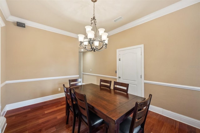 dining room with crown molding, a chandelier, and dark hardwood / wood-style floors