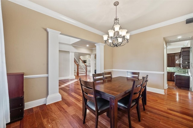 dining area featuring a chandelier, dark hardwood / wood-style flooring, and crown molding