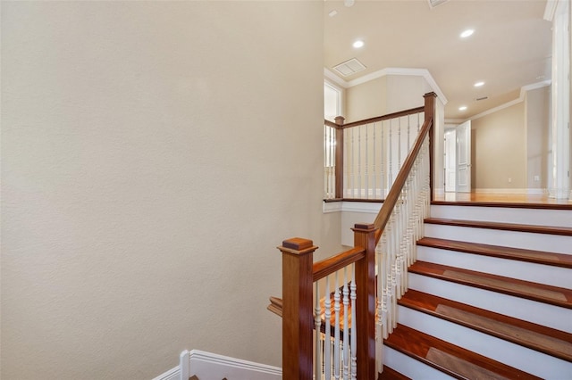 staircase featuring decorative columns and crown molding