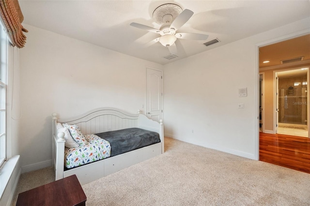 bedroom featuring ceiling fan and light carpet