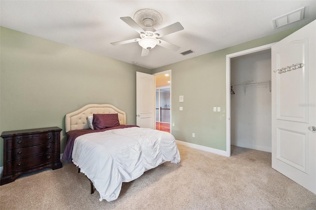 carpeted bedroom featuring a closet and ceiling fan