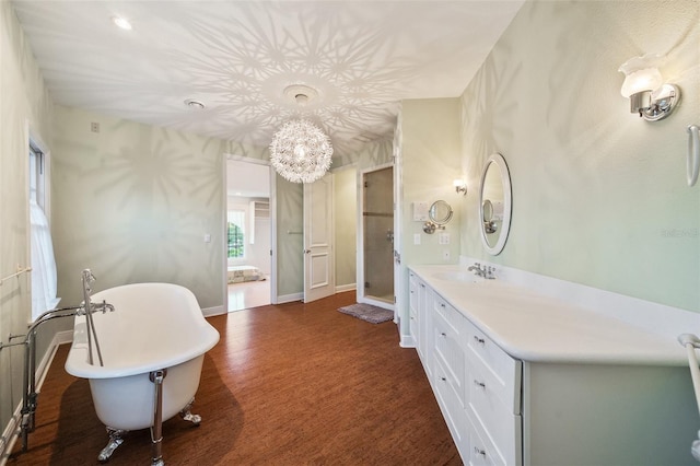 bathroom featuring vanity and independent shower and bath