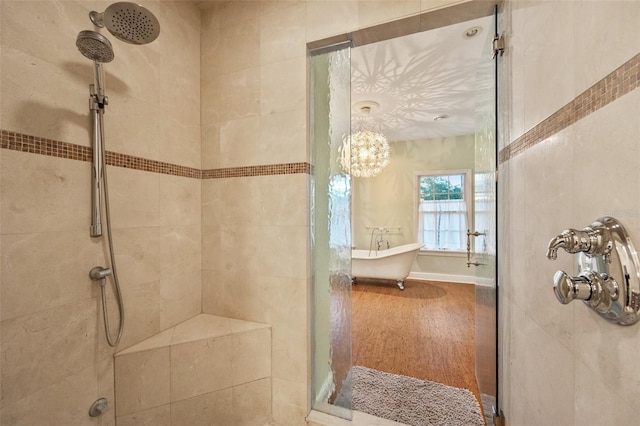 bathroom featuring hardwood / wood-style floors and plus walk in shower