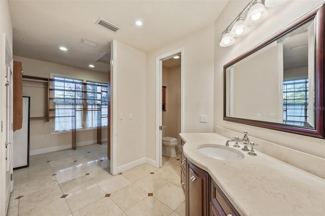 bathroom featuring vanity and toilet