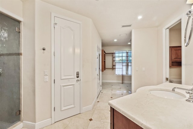 bathroom with tile patterned floors, vanity, an enclosed shower, and toilet