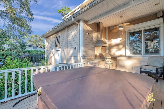 wooden terrace with area for grilling and exterior kitchen