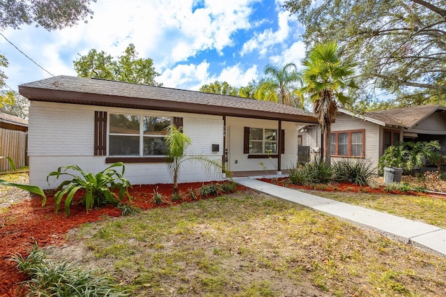 ranch-style home with a front lawn