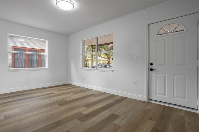 foyer featuring a textured ceiling and hardwood / wood-style flooring