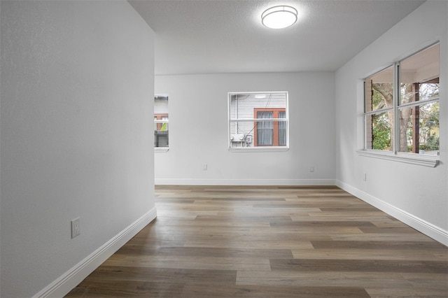 spare room with hardwood / wood-style flooring