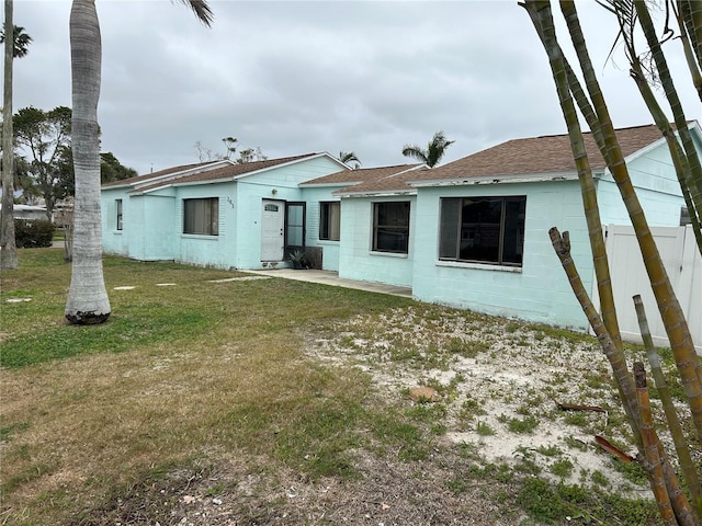 rear view of house with a yard