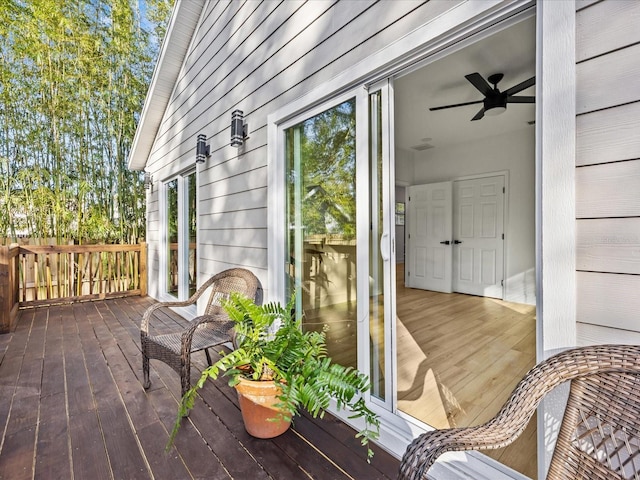 wooden terrace featuring ceiling fan