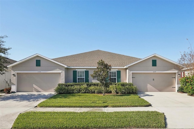 ranch-style house featuring a garage and a front yard