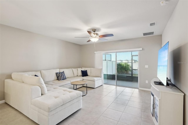 living room with ceiling fan and light tile patterned floors