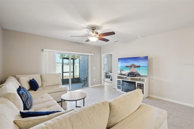 tiled living room featuring ceiling fan