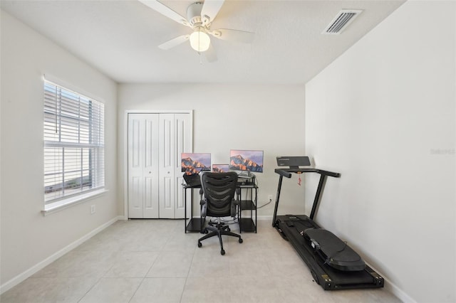 office area with light tile patterned floors and ceiling fan