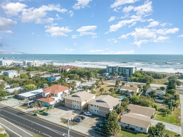 drone / aerial view featuring a water view and a beach view