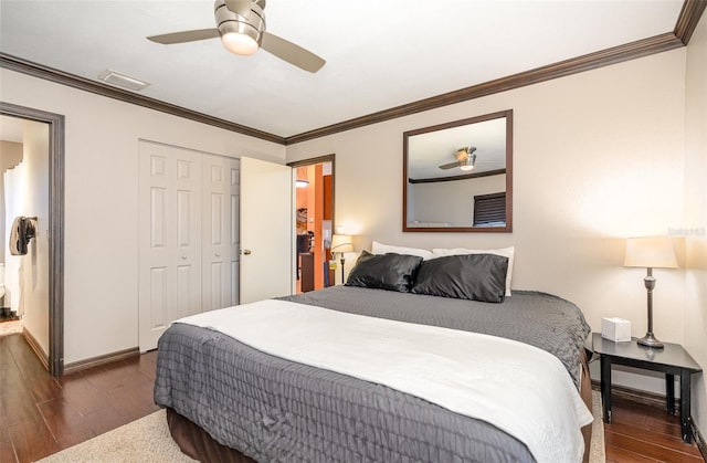 bedroom featuring ornamental molding, a closet, ceiling fan, and dark wood-type flooring