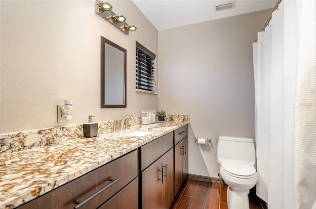 bathroom featuring vanity and toilet