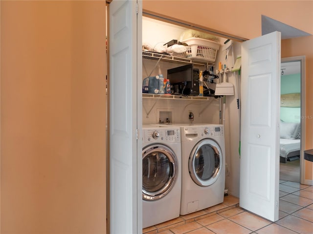 laundry area with laundry area, light tile patterned floors, and separate washer and dryer