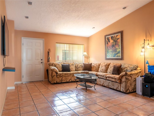 living area with light tile patterned flooring, a textured ceiling, baseboards, and vaulted ceiling