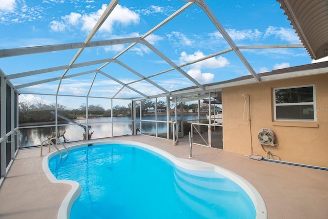 view of swimming pool with a lanai, a patio area, and a water view