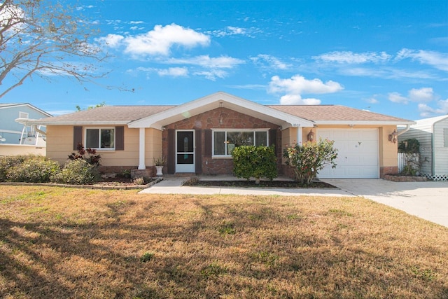 ranch-style house featuring a garage and a front lawn