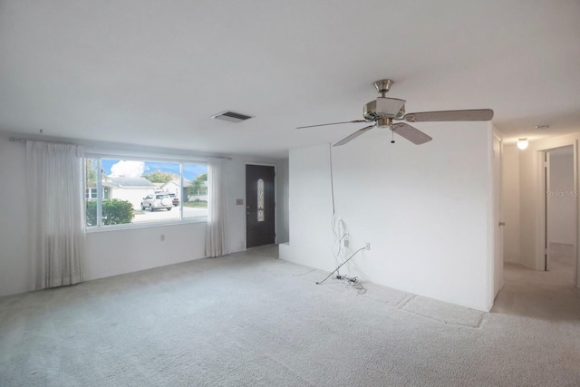 carpeted empty room featuring ceiling fan